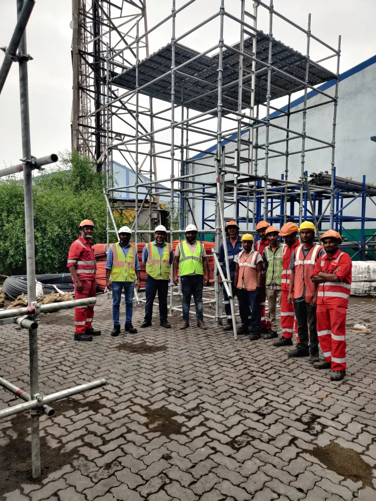 Project team beside an assembled scaffolding tower