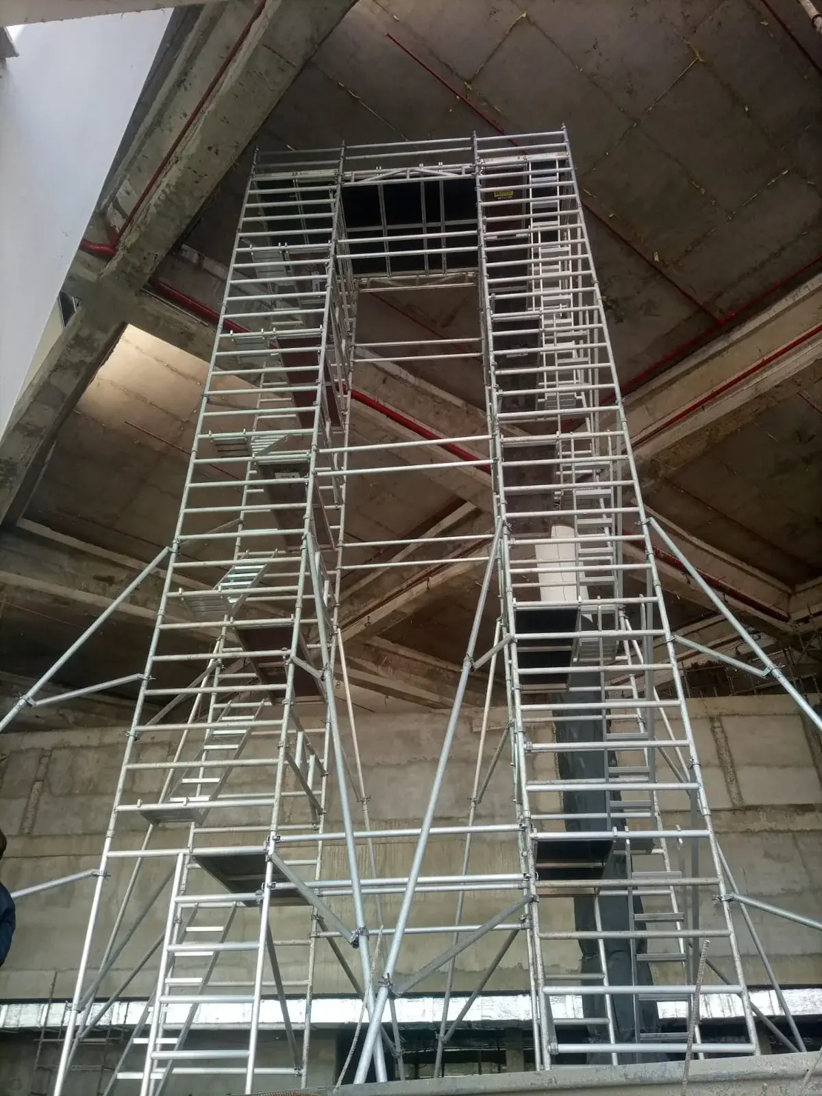 Connected aluminium bridge-scaffold towers installed below a concrete structure