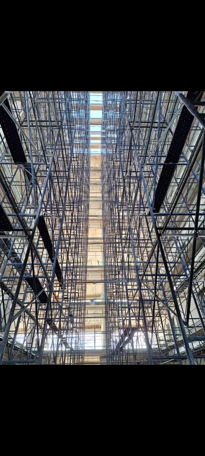 Dense H-frame scaffolding installed through a tall internal work zone