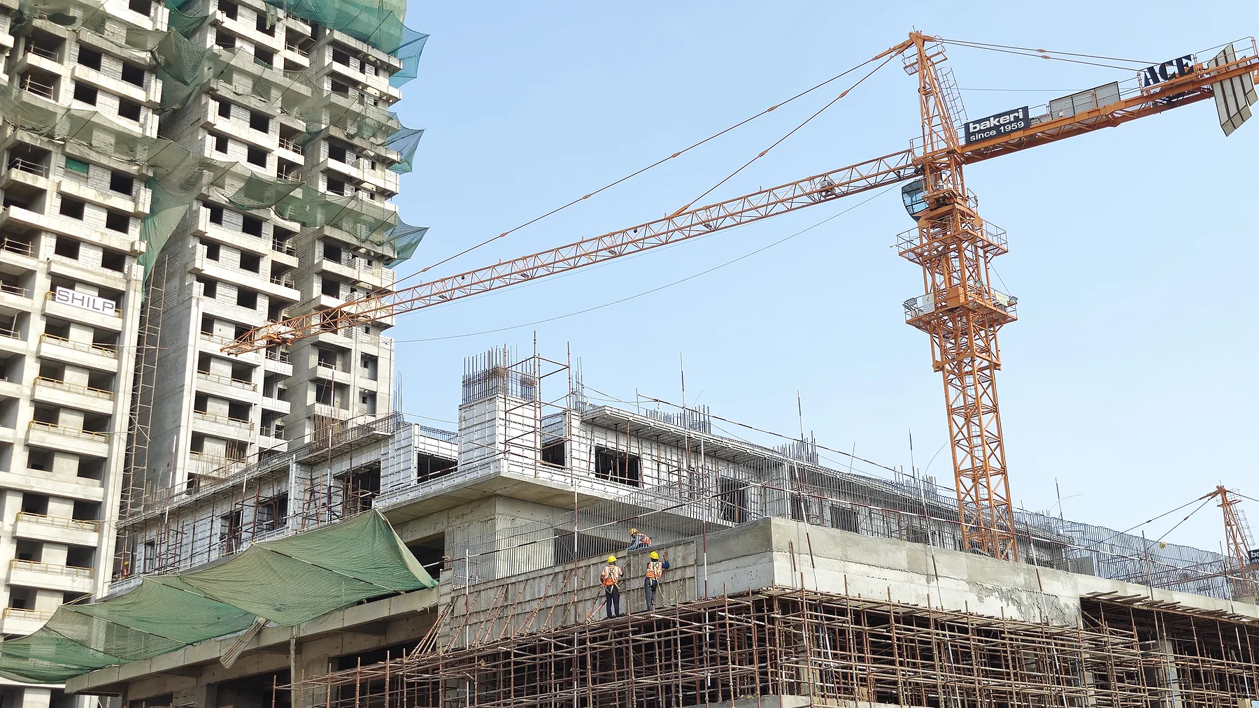Aluminium wall-and-slab formwork in active multi-storey construction at GIFT City.